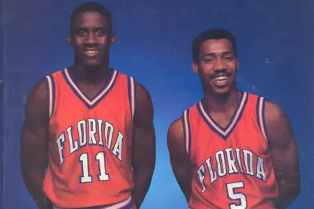 Vernon Maxwell and Andrew Moten pose wearing orange uniforms in a studio photo for the cover of the 1986-87 media guide.