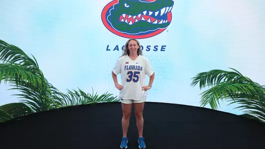 Ella Davis in front of Florida Lacrosse logo