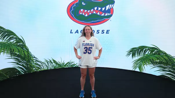 Ella Davis in front of Florida Lacrosse logo