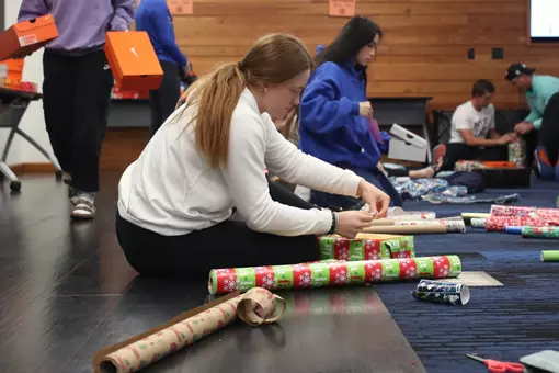 Jocelyn Erickson wrapping presents with Gator Tracks, which provides shoes for students attending one of seven schools in Alachua County