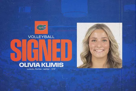 A female smiles in her head shot on a blue background with her name, Olivia Klimis