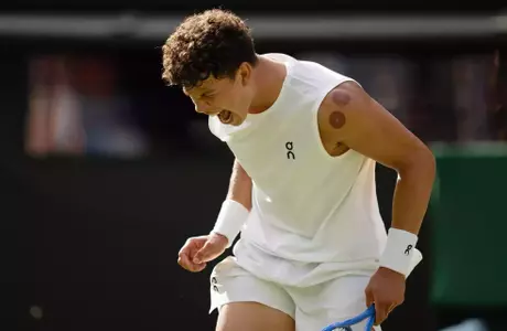 Ben Shelton of the United States reacts to a point during his match against Jannik Sinner of Italy on day 10 at All England Lawn Tennis and Croquet Club.