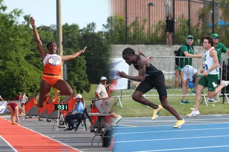 An athlete in orange and white jumps into a sand pit, an athlete in black runs on a gray track