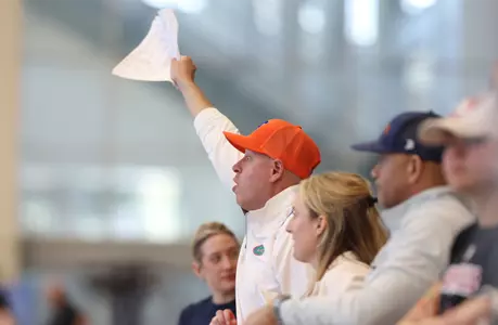 Whitney Hite (orange hat, white polo) cheering on the Gators at the 2026 NCAA Championships.