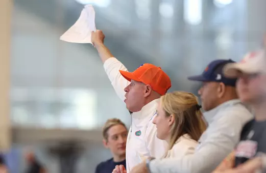 Whitney Hite (orange hat, white polo) cheering on the Gators at the 2026 NCAA Championships.
