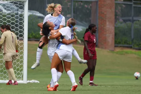 Kyra Taylor (lower left), Zoe Main and Sophia Sindelar celebrate Taylor's goal versus Florida State 260823