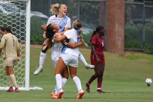 Kyra Taylor (lower left), Zoe Main and Sophia Sindelar celebrate Taylor's goal versus Florida State 260823