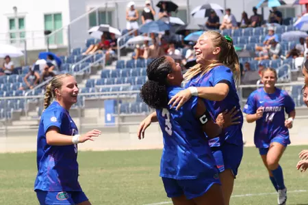 Addy Hess (right with green bow) celebrates her goal with Kyra Taylor at Florida Atlantic 260830