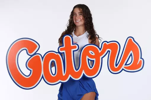 Freshman Women's Tennis Player Capucina Jauffret posed with a script "Gators" sign at media day