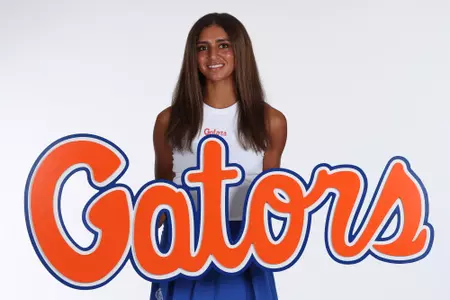 Women's Tennis player Jana Hossam posed at media day with a giant script Gators logo