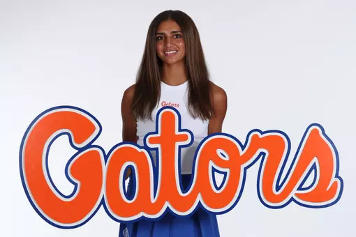 Women's Tennis player Jana Hossam posed at media day with a giant script Gators logo