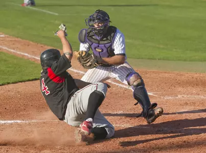 Danny Bethea readies to tag out Chris Vargas at the plate after a throw from right fielder Tyler Bair during the first game of a March 12 doubleheader with Academy of Art.