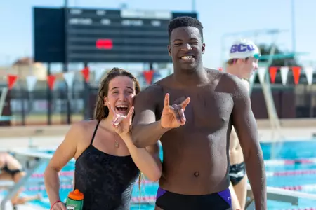 Male and female swimmer lopes up outside of pool