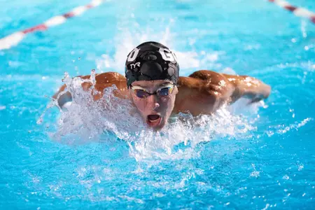 swimmer in the middle of race with head barely above water