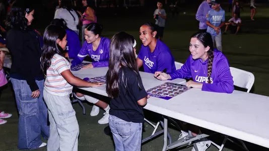logan and kaela signing autographs fro youth teams