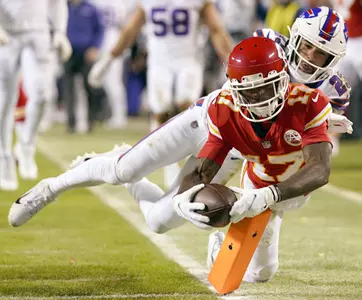 Kansas City Chiefs wide receiver Mecole Hardman (17) dives for a touchdown past Buffalo Bills safety Micah Hyde (23) during the third quarter of the AFC Divisional playoff football game at GEHA Field at Arrowhead Stadium. Mandatory Credit: Jay Biggerstaff-USA TODAY Sports