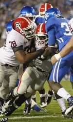 Georgia running back Washaun Ealey is helped by teammate Georgia offensive tackle Josh Davis (78) as he crosses the goal line in front of Kentucky cornerback Cartier Rice (35) during the first half.  (AP Photo/Ed Reinke)