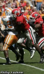 Akeem Dent and Marcus Dowtin make a tackle during the Bulldogs' game with Tennessee on Saturday in Athens. (Photo by Phillip Faulkner)