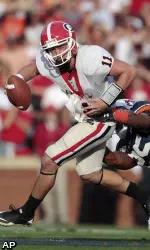 Georgia quarterback Aaron Murray (11) escapes the pressure of Auburn's Daren Bates (25) in the first half. (AP Photo/Dave Martin)