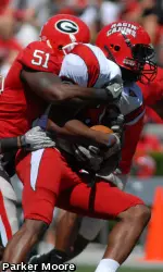 Georgia's Christian Robinson and Akeem Dent make a tackle during Saturday's game at Sanford Stadium. (Photo by Parker Moore)