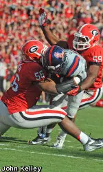 End Garrison Smith (56) and Linebacker Jordan Jenkins (59) make a tackle