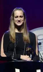 Megan Romano accepts one of her two Golden Goggles awards on Sunday.
