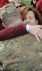 Specialist Robert Owens greets his mother Mary during a break in the game.
