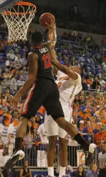 Kenny Gaines blocks the shot by Florida Gators guard Kasey Hill.