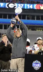 Coach Mark Richt hoist the Belk Bowl Trophy