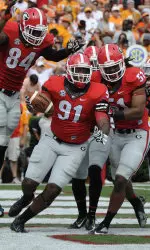 Dawson celebrates with his teammates after recovering a fumble for a touchdown.