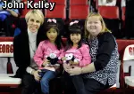 Jainie Day, Lexie Day and Tonya Day joined former coach Suzanne Yoculan (left) to watch a Gymdogs meet as part of a silent auction item benefitting Gymdogs United.