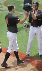 Teammates welcome Stephen Wren (11) following his first career home run.
