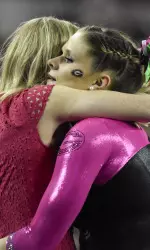 Georgia's Brandie Jay hugs Coach Danna Durante after performing her floor routine. (Photo by David Barnes)