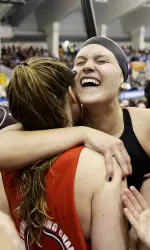 Georgia's Olivia Smoliga, center right, hugs teammate Kylie Stewart after they won the NCAA women's swimming and diving championships at Georgia Tech, Saturday, March 19, 2016, in Atlanta. (AP Photo/David Goldman)