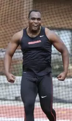 Ashinia Miller celebrates after he won the shot put and was second in the discus.