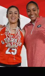 Simone Costa inks with head coach Joni Taylor and the Lady Dogs.