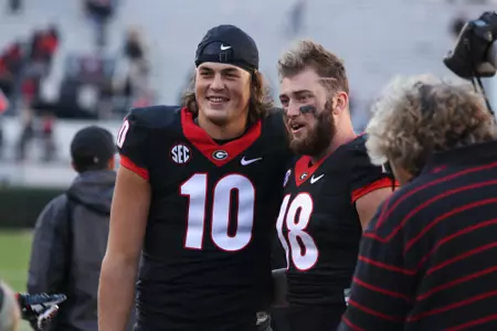 Jacob Eason (10) and tight end Isaac Nauta (18)