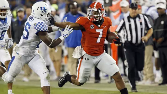 D'Andre Swift (7) throws a stiff arm at Kentucky