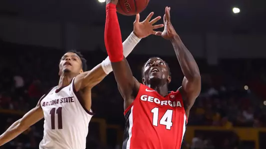 Georgia Bulldogs guard Tye Fagan (14) drives to the basket against Arizona State Sun Devils guard Alonzo Verge Jr. (11) in the first half at Desert Financial Arena. Mandatory Credit: Mark J. Rebilas-USA TODAY Sports