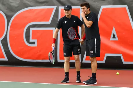 Georgia's Walker Duncan chats with his doubles partner Georgia's Emil Reinberg during a men's tennis match against the University of Florida in Athens, Ga., on Friday, Mar. 15, 2019. (Photo by Kristin M. Bradshaw)