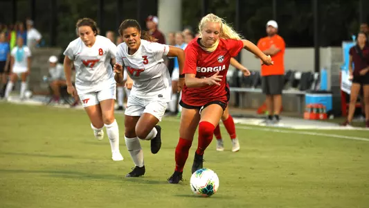 Georgia forward Reagan Glisson (34) dribbles past Virginia Tech defender Jaylyn Thompson (3) during a game against Virginia Tech at the Turner Soccer Complex in Athens, Ga., on Friday, Aug. 30, 2019. (Photo by Tony Walsh)