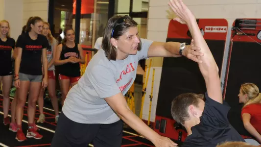 Katrin Koch Director of Strength and Conditioning for Olympic Sports instructs a runner during cross country training on Monday, August 17, 2015 in Athens, Ga.(Photo by John Kelley)