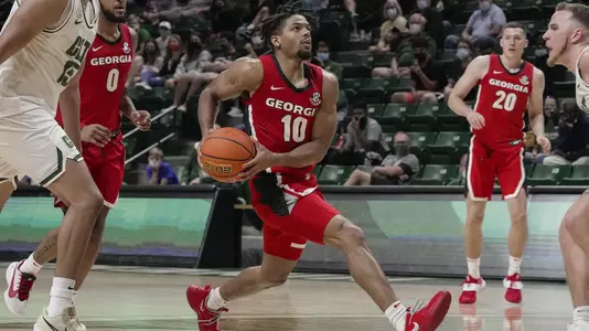 Aaron Cook in action on Oct 24, 2021; Charlotte, North Carolina, USA; Georgia Bulldogs guard Aaron Cook (10) breaks to the basket against Charlotte 49ers guard Austin Butler (2) during the second half at Halton Arena in Charlotte, NC.