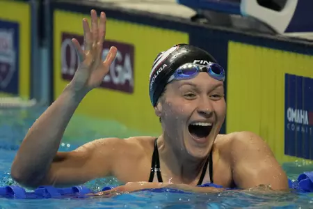 Olivia Smoliga reacts after women's 100 freestyle during wave 2 of the U.S. Olympic Swim Trials on Thursday, June 17, 2021, in Omaha, Neb. (AP Photo/Charlie Neibergall)