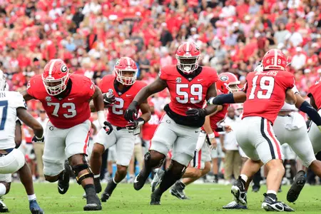 Georgia running back Kendall Milton (2) follows the blocks oo offensive linemen Xavier Truss (73) and Broderick Jones (59) during the Bulldogs 33-0 win over Samford in a game played September 10, 2022, at Sanford Stadium at the University of Georgia in Athens, GA. Photo credit Perry McIntyre.