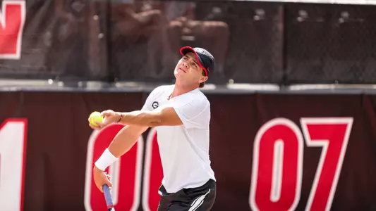 Trent Bryde preparing to toss up a serve at the Southern Intercollegiate Championships in the team's battle against Virginia.