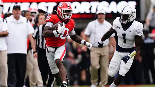 Georgia wide receiver Kearis Jackson (10) tries to outrun Samford cornerback Kourtlan Marsh (1) after a catch during the first half of an NCAA college football game, Saturday, Sept. 10, 2022 in Athens, Ga. (AP Photo/John Bazemore)