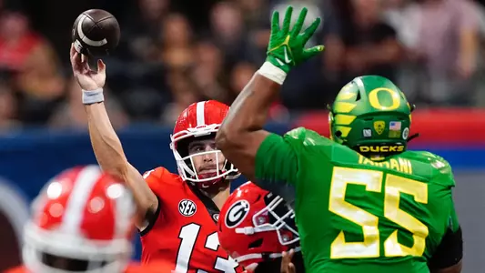 Georgia quarterback Stetson Bennett (13) throws under pressure from Oregon defensive lineman Taki Taimani (55) in the first half of an NCAA college football game Saturday, Sept. 3, 2022, in Atlanta. (AP Photo/John Bazemore)