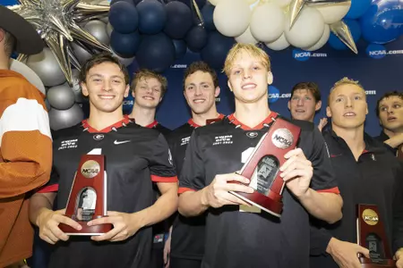 Luca Urlando, Matthew Sates, Jake Magahey, and Zach Hils celebrate their second-place finish in the 800 freestyle relay at the 2022 NCAA Men's Swimming & Diving Championships.
