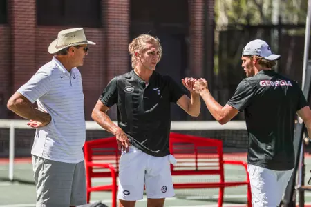 Georgia head coach Manuel Diaz, Georgia tennis player Philip Henning, and Georgia tennis player Erik Grevelius during a match against LSU at Dan McGill Tennis Complex in Athens, Ga., on Sunday, April 3, 2022. (Photo by Mackenzie Miles)